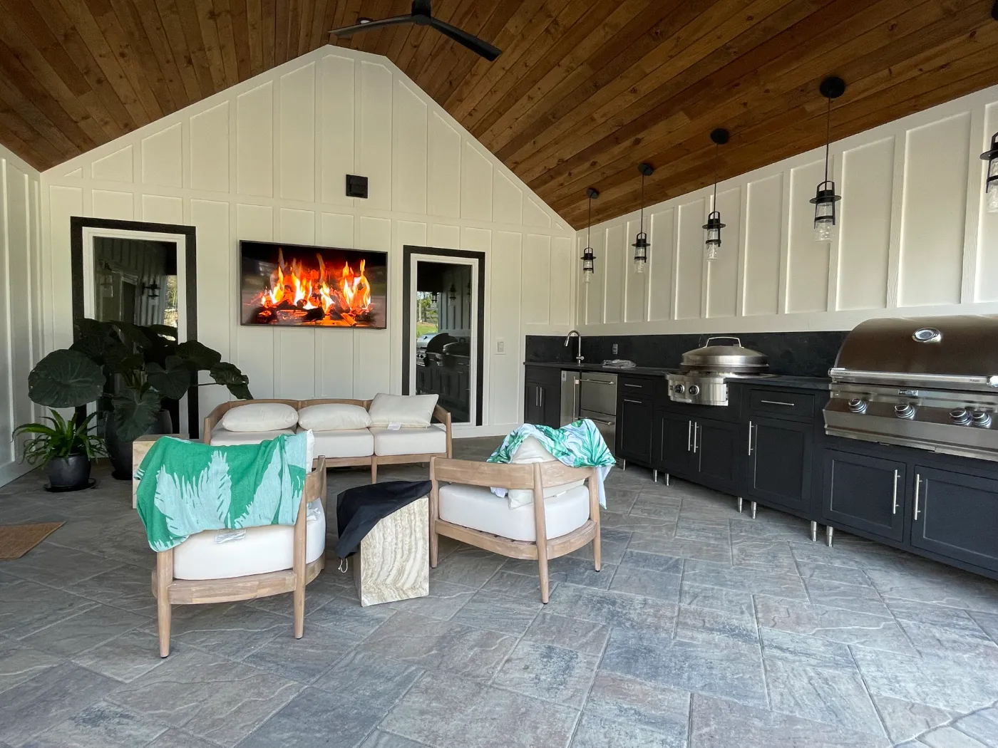 Outdoor kitchen with a TV built for the patio by Home Tech Solutions